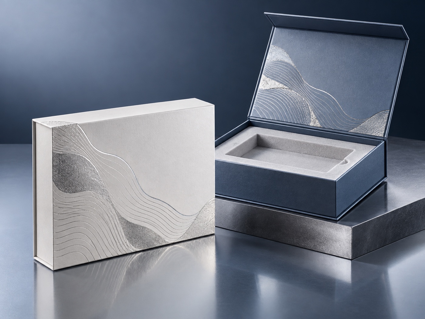 Pearl white and slate blue rigid boxes with silver foil patterns and fitted insert